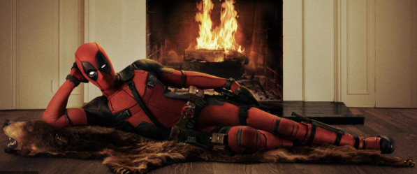 Ryan Reynolds dressed as Deadpool lounging on a bearskin rug in front of a roaring fire, reminiscent of the famous Burt Reynolds image.
