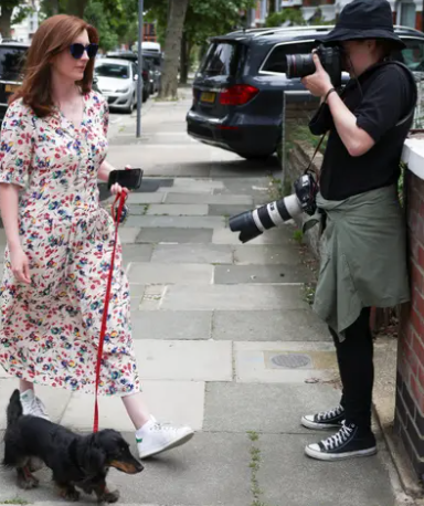 Paparazzi hounds Martha Hancock as she walks her dog.